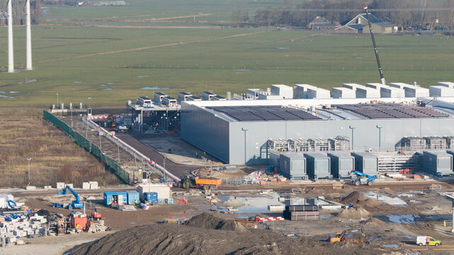 Groningen, Netherlands - 20 January 2026: Aerial view of Datacenter Westpoort under construction with heavy machinery, cooling systems, and solar panels on the roof.