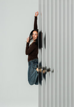 3D vertical glass reveal with woman jumping in studio