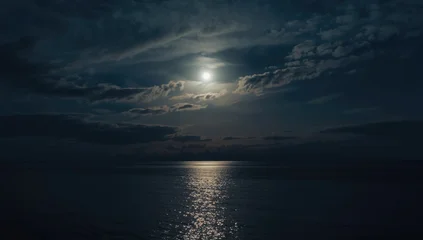 Calm Seascape Under Super Moon Nighttime Sky with Moving Clouds, Reflective Water © NeuralNiche