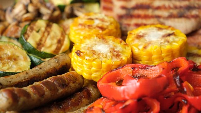 Assorted grilled meat, sausages and vegetables background