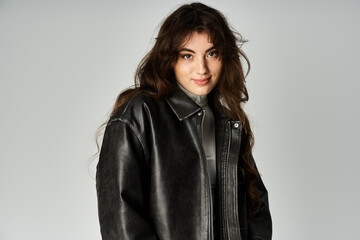 Obraz premium Beautiful young woman expresses her unique fashion sense in a stylish studio setting