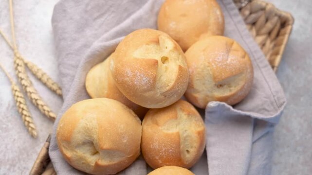 Freshly baked kaiser rolls in wicker basket