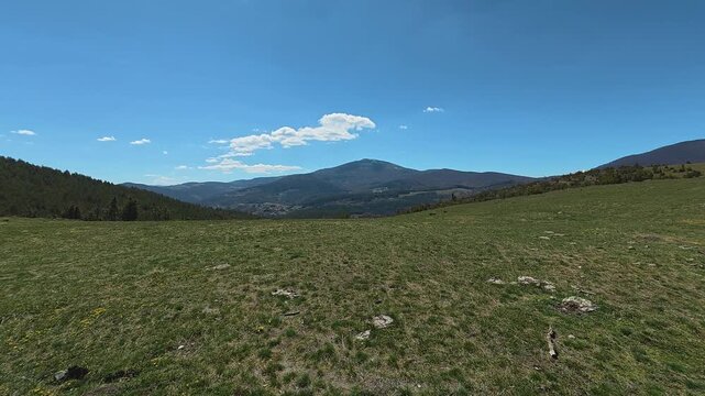 Open grassland stretches under bright blue skies. Mount Goc, Ljukten peak. Balkans, Serbia
