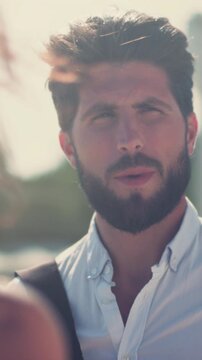 Luminous discussion with smiling backpacker, Warm sunlight illuminates jovial man with beard and travel style