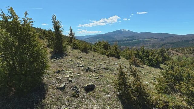 Clear sky above rugged mountains and green hills. Mount Goc, Ljukten peak. Balkans, Serbia