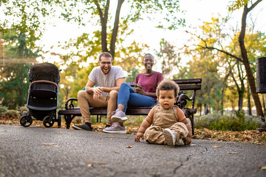 Joyful moments in the park with family and a curious toddler