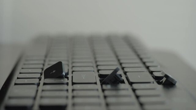 Detached keycaps scattered on keyboard, closeup of broken keys and empty sockets on desk, technician action implied with tools and careful inspection, aftermath of impact