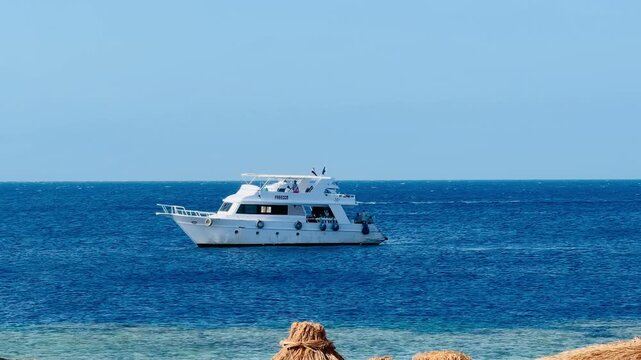 White motor yachts sailing open Red Sea waters near Sharm El Sheikh 5 star hotel resort in Egypt, premium VIP yachting lifestyle charter high quality video for summer tourism cruise travel holiday