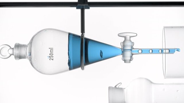 Vertical close-up of transparent blue liquid draining from a separatory funnel dripping through the opened valve and causing rising bubbles inside on clean white surface