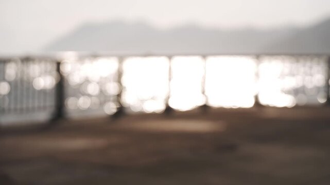 A coastal deck fence with a reflective ocean surface in the background
