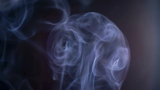 Abstract blue smoke swirling on dark background with soft light and mysterious atmosphere