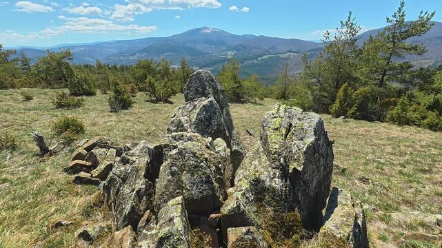Rugged rocks stand tall on sunlit hillside. Mount Goc, Ljukten peak. Balkans, Serbia