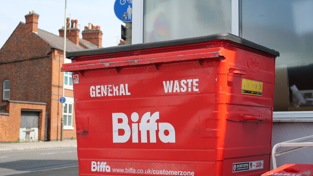 Biffa large red commercial wheelie bin for general waste on a street sidewalk in Leicester, England, UK on May 9, 2026