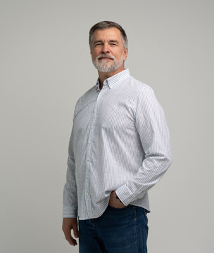 portrait of confident businessman. Entrepreneur in blue shirt, mature age man standing, isolated on white background