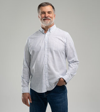 portrait of confident businessman. Entrepreneur in blue shirt, mature age man standing, isolated on white background
