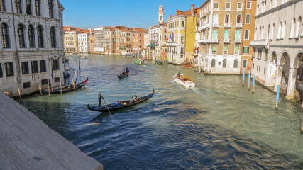 Gondolier navigate a gondola near the Rialto Bridge, Venice, Italy. © An Instant of  Time
