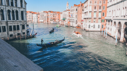 Gondolier navigate a gondola near the Rialto Bridge, Venice, Italy. © An Instant of  Time