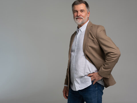 Entrepreneur in jacket smiling, Happy mid adult, mature age man standing, smiling