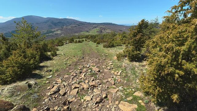 Dirt path winds through rocky hillside. Mount Goc, Ljukten peak. Balkans, Serbia