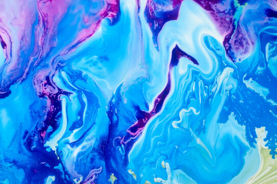 Colorful abstract painting with blue, purple, and pink swirls on canvas