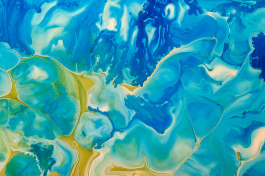 Swirling patterns of blue and yellow colors in an abstract design on a canvas