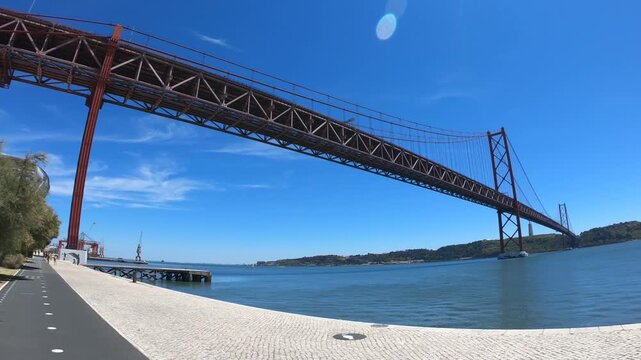 Christ-King and the 25 April Bridge (Ponte 25 de Abril), a steel suspension bridge located in Lisbon, Portugal, crossing the Tagus River (Rio Tejo).