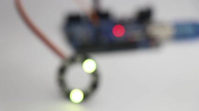 LED light of RGB type displaying different colors and patterns controlled by a programmable micro controller on a blurred background