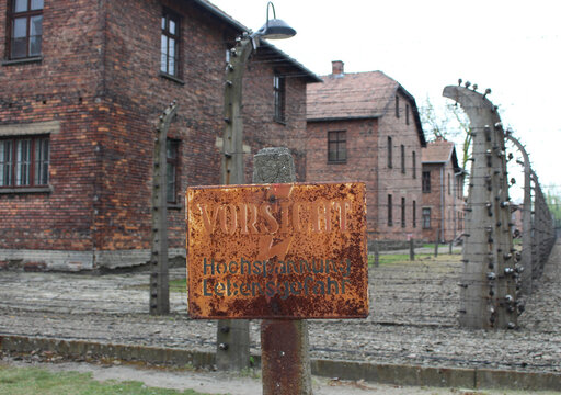 Oświęcim / Poland - April 27, 2019 - Electric fence with barbed wire in Auschwitz I German Nazi Concentration and Extermination Camp on the outskirts of Oswiecim, Poland.