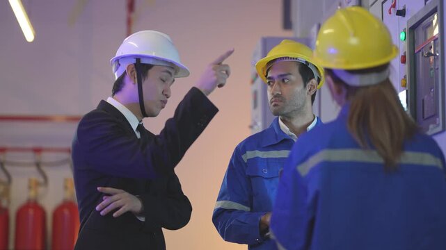 A professional green building consultant in a business suit shaking hands with a female mechanical site engineer after a successful solar panel commissioning setup.