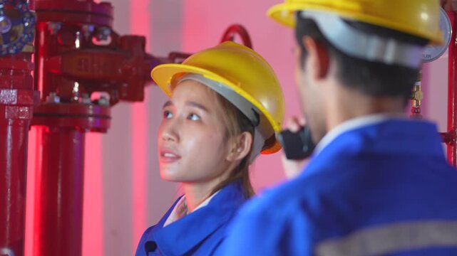 Chinese female hardware specialist holding a digital tablet to demonstrate a semiconductor RAM bandwidth efficiency dashboard to her Indian manager.