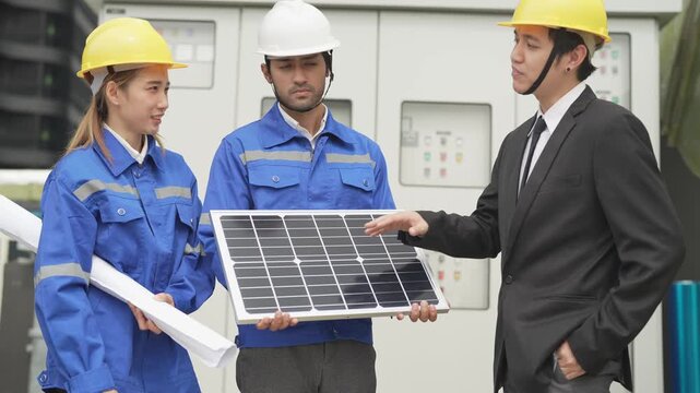 A professional male green building consultant in a business suit explaining mechanical ventilation workflows to a site engineer inside a facility pump room.