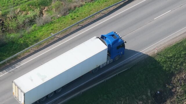 Lorry truck moving high speed on highway, aerial view