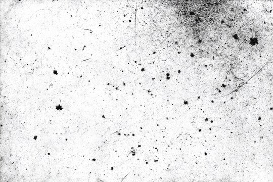 Abstract texture of scattered dark particles and subtle scratches on a white surface