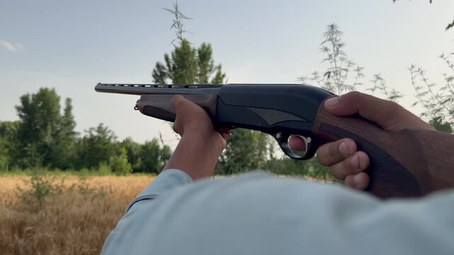 Man fires smoothbore shotgun at clay target, autumn sun glowing, slow-motion skeet training.