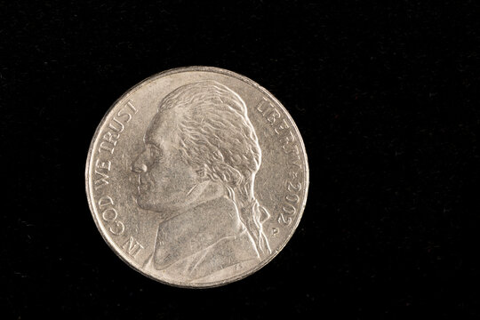 a 5 cent coin on a deep black background