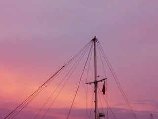 Fototapeta premium Sailboat Mast Against Colorful Sunset Sky