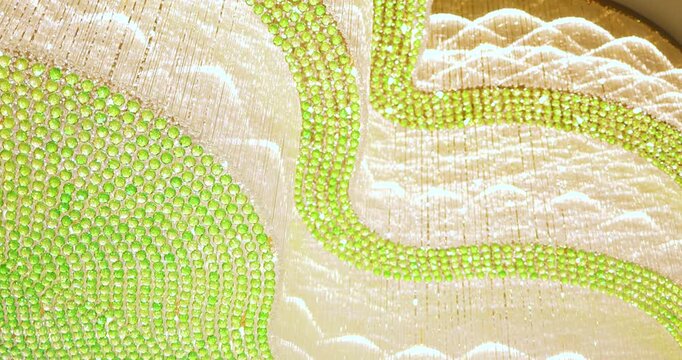 Luxury golden chandelier with green crystals, sparkling light and elegant motion. Ideal background for design, advertising, and premium video projects