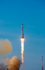 Take-off of a real launch vehicle from a spaceport. A rocket takes off into the sky against a background of clouds. Startup concept, power of science and technology. © Vera