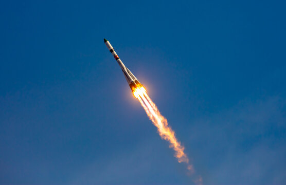 Take-off of a real launch vehicle from a spaceport. A rocket takes off into the sky against a background of clouds. Startup concept, power of science and technology.