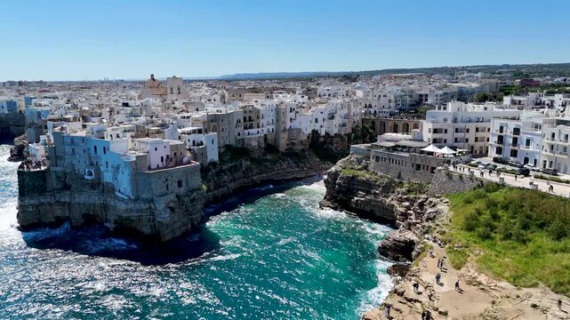 Polignano a Mare with Lama Monachile beach. Aerial 4K drone video footage with panorama view of stunning coastal townscape in Puglia, southern Italy