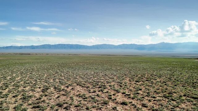 Drone shot of country road at spring steppe in Kazakhstan