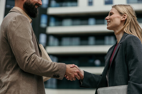 Business professionals shaking hands, sealing important deal