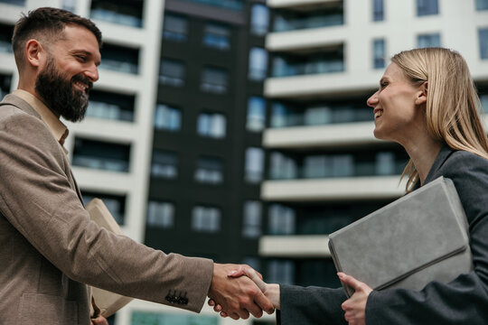 Business partners shaking hands creating successful deal agreement