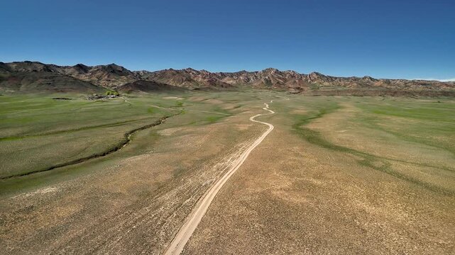Drone shot of country road at spring steppe in Kazakhstan