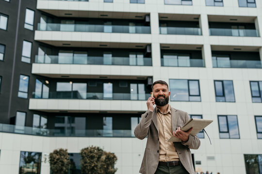 Real estate agent talking on phone discussing property