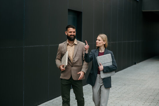 Business colleagues walking and talking during meeting