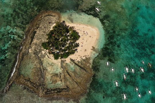 Guyam Island is a tiny, tear-drop shaped islet just off the coast of General Luna, Siargao in the Philippines. Known for its powdery white sand and dense canopy of coconut palms