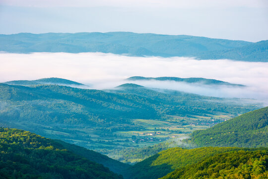 carpathian mountain landscape on a foggy morning. outdoor adventure with stunning view in morning light. mountainous countryside of ukraine in summer. rolling hills. scenic travel background