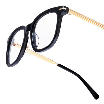 Elegant black eyeglasses with gold metal temples isolated on white background