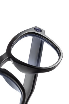 Close up of smart glasses frame with integrated camera lens isolated on white background